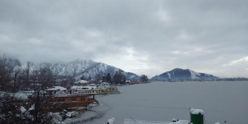 a view of a lake with mountains in the background at Houseboats Jackson Heights in Srinagar