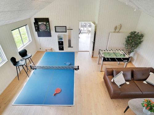 a living room with a ping pong table in it at Luxury Retreat with Pool - By Traum Ferienwohnungen in Nørre Nebel