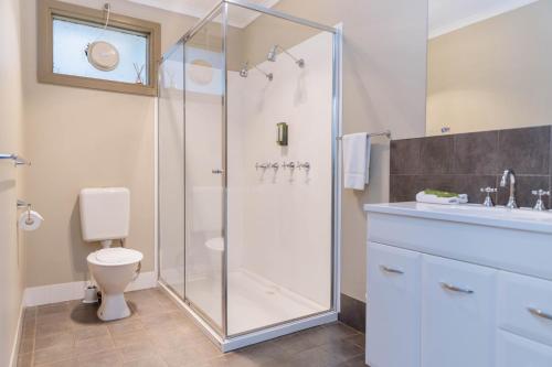 a bathroom with a shower and a toilet and a sink at The Bright Motor Inn in Bright