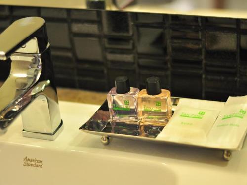 a tray with two bottles of perfume on a counter at Tanzeno Hotel in Nong Khai
