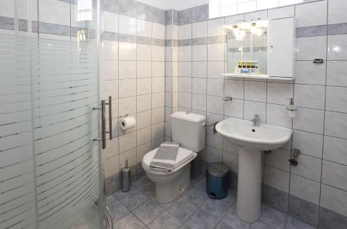 a bathroom with a toilet and a sink at Nereids Apartments and Studios in Chrysi Ammoudia