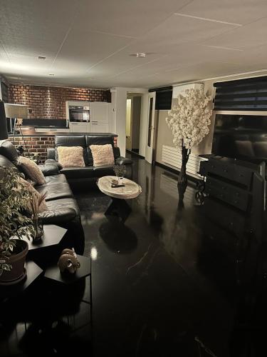 a living room with a couch and a table at woonboot de dobber loosdrechtse plassen 4-8 personen in Loosdrecht