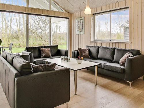 a living room with two couches and a table at 5 star holiday home in Kappeln in Kappeln