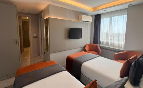a hotel room with two beds and a tv at AHC Old City Hotel in Istanbul