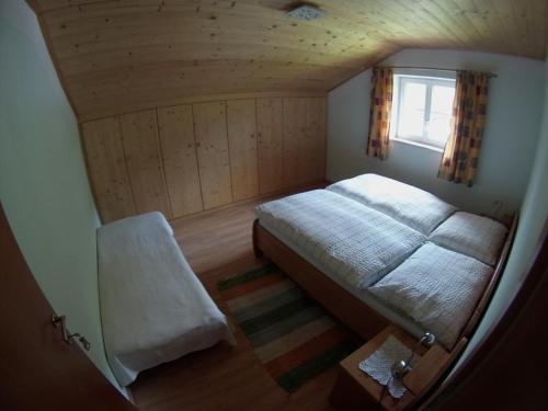 a small bedroom with a bed and a window at Haus Ebner Johann in Hintersee