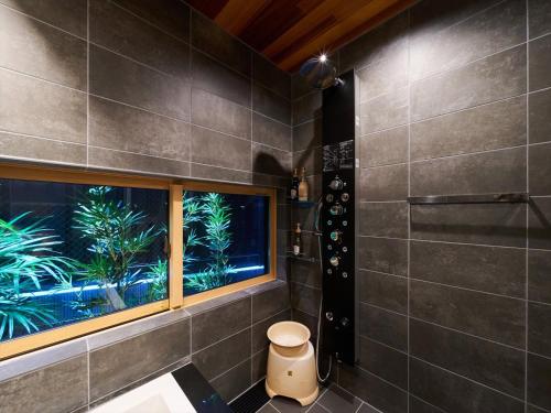 a bathroom with a large window and a shower at Yadoya Asakusa Asagao in Tokyo
