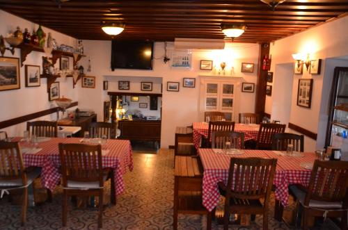 a restaurant with tables and chairs in a room at Aliye Hanim Hotel in Ayvalık
