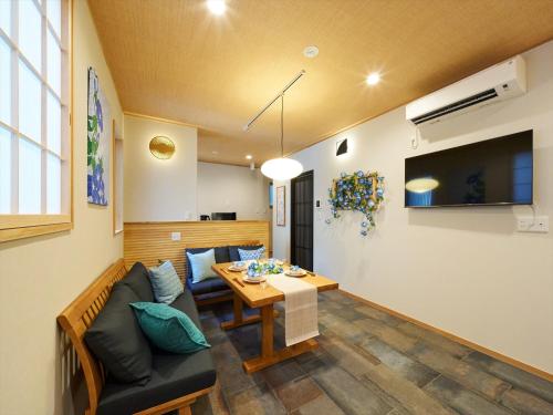 a living room with a couch and a table at Yadoya Asakusa Asagao in Tokyo