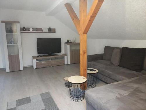 a living room with a couch and a flat screen tv at Stilvoll übernachten in Sonneberg in Sonneberg