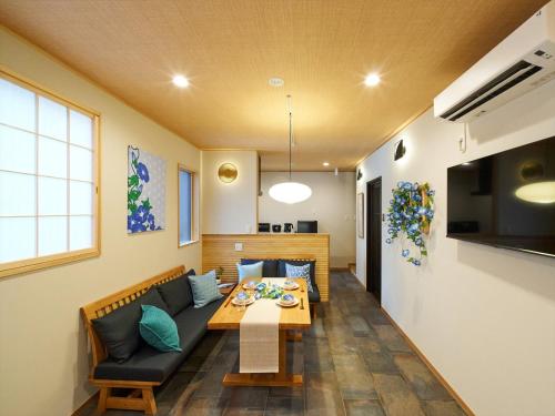 a living room with a couch and a table at Yadoya Asakusa Asagao in Tokyo