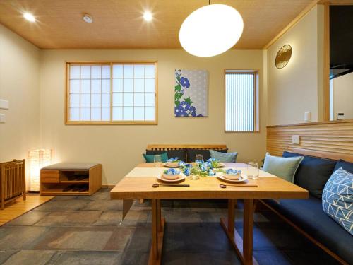 a living room with a table and a couch at Yadoya Asakusa Asagao in Tokyo