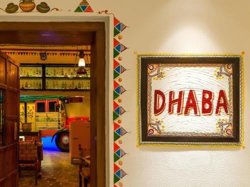 a sign on the wall of a restaurant with a fire truck at The Claridges New Delhi in New Delhi