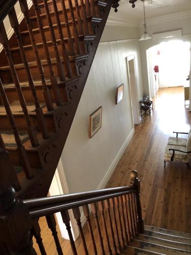 a staircase in a building with a stair case at Eddy's of Canowindra in Canowindra