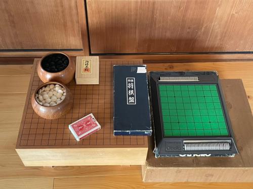 a table with a chessboard and a box on it at ゲストハウスKoToKoTo in Makurazaki