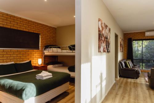 a bedroom with a bed and a bunk bed at The Bright Motor Inn in Bright
