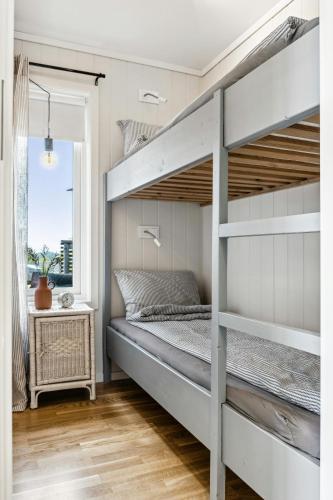 a bedroom with bunk beds and a window at Cabin With 360-Degree Views In Risør in Søndeled