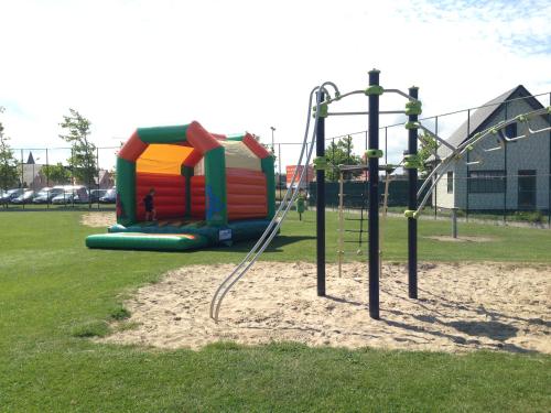 a playground with a slide in a park at Camping Ter Hoeve in Bredene