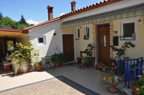 a house with a courtyard with potted plants at Apartments and Rooms Knez in Portorož