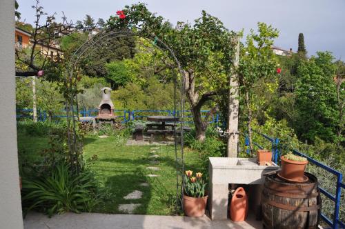 a garden with an arbor and a picnic table at Apartments and Rooms Knez in Portorož