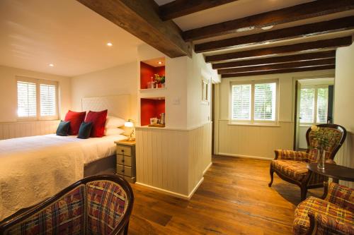 a bedroom with a bed and a table and chairs at The Broadmead Boutique B&B in Tenby