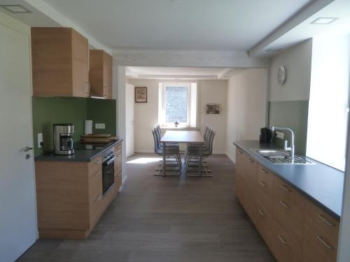 a kitchen with a table and a dining room at Cottage in Kuchelscheid with Terrace in Küchelscheid