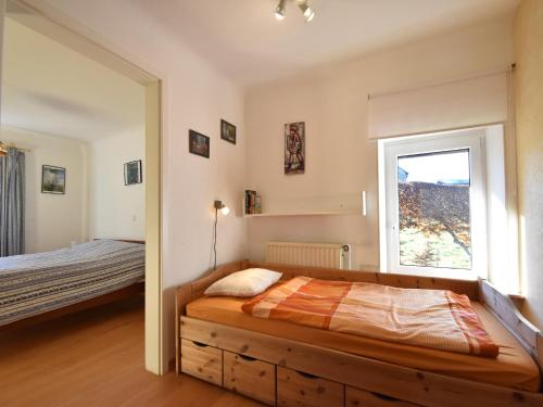 a bedroom with a bed and a window at Cottage in Kuchelscheid with Terrace in Küchelscheid
