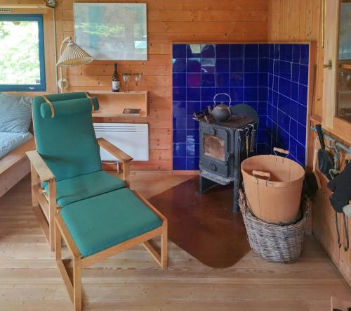 a living room with a chair and a stove at Norwegian Architect-Designed Cabin From 1972 in Trans