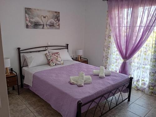 a bedroom with a bed with two towels on it at PENELOPE'S apartment in Kefalonia