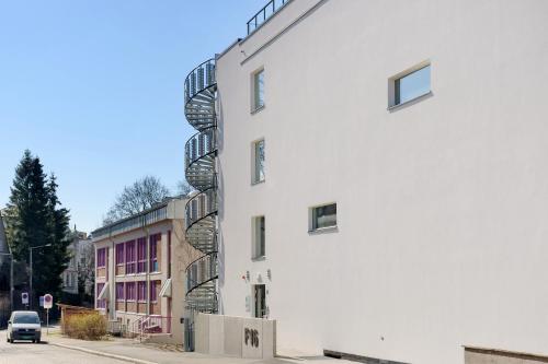 a white building with balconies on the side of it at The Apartments Company - Majorstuen in Oslo