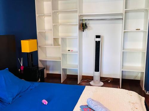 a bedroom with white shelves and a bed at Villa F5 vue sur mer 