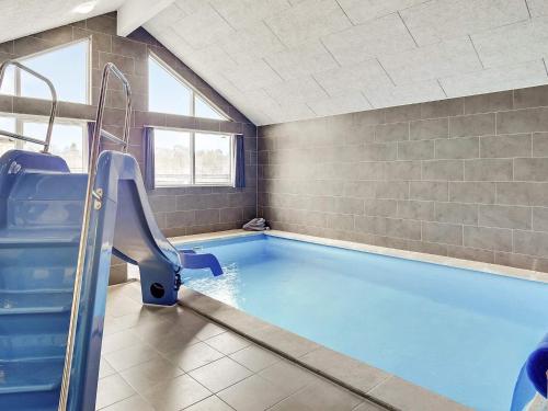 a swimming pool with a slide in a room at Luxury Retreat with Pool - By Traum Ferienwohnungen in Jægerspris