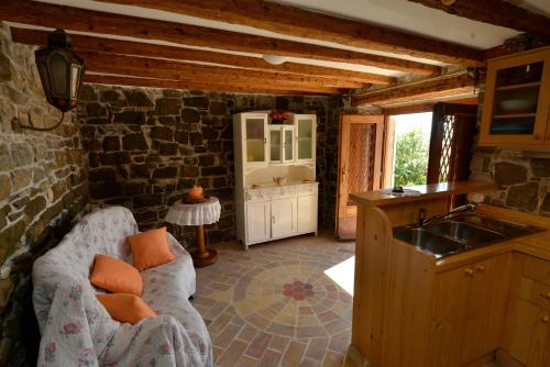 a kitchen with a couch and a sink in a room at Apartments Maja in Piran