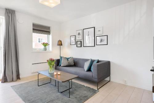 a living room with a couch and a table at The Apartments Company - Majorstuen in Oslo