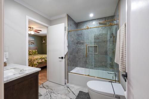 a bathroom with a shower and a toilet and a sink at Naples Getaway in Naples