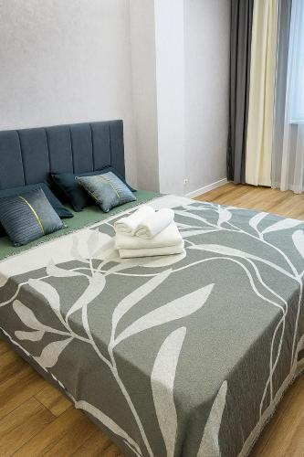 a bedroom with a bed with a blanket on it at Family Comfort 97 in Uralsk
