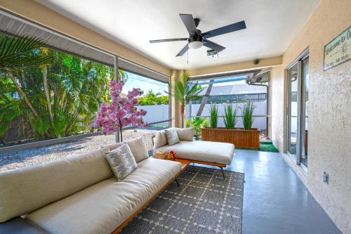 a living room with a couch and a ceiling fan at Naples Getaway in Naples