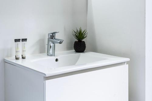 a white bathroom sink with a faucet at Budget Room W Kitchen, Station Close, Wifi Access in Tilburg