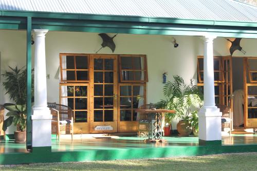 a house with a pool in front of it at York Lodge in Harare