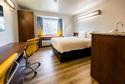 a hotel room with a bed and a desk at Microtel Inn & Suites Cheyenne in Cheyenne
