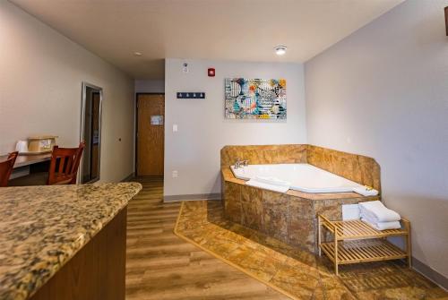 a large bathroom with a tub in a room at Microtel Inn & Suites Cheyenne in Cheyenne