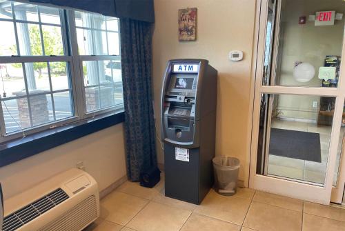 an atm machine in a room next to a window at Microtel Inn & Suites by Wyndham Waynesburg in Waynesburg