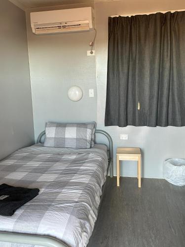 a small bedroom with a bed and a window at The Eulo Queen Hotel 