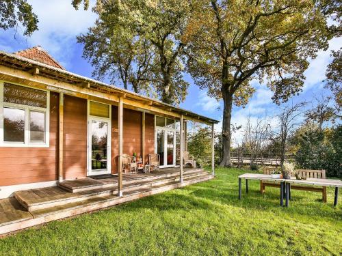 a home with a large deck with a picnic table at Holiday Home in Tripscompagnie near Nature in Tripscompagnie