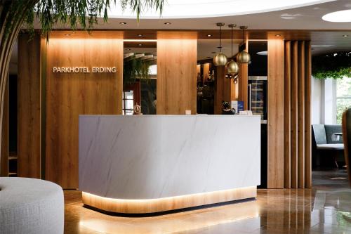a reception desk in a lobby of a restaurant at Best Western Plus Parkhotel Erding in Erding