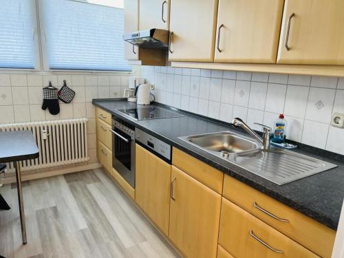 a kitchen with a sink and a counter top at Zur Seeschwalbe in Scharbeutz