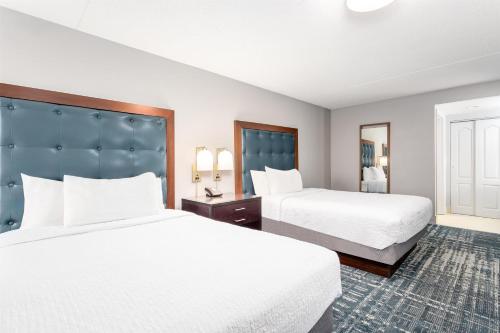a hotel room with two beds and a large headboard at Homewood Suites by Hilton Lexington Fayette Mall in Lexington