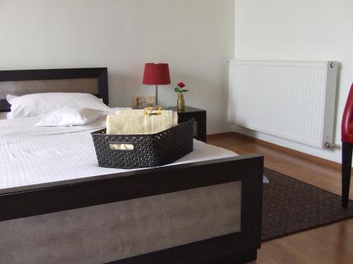 a bedroom with a bed with a basket on it at Pensiunea Caramell in Cluj-Napoca