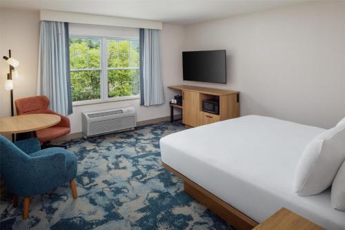 a hotel room with a bed and a television at Hampton Inn & Suites North Conway in North Conway