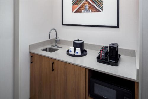 a kitchen with a counter with a sink and a microwave at Hampton Inn & Suites North Conway in North Conway