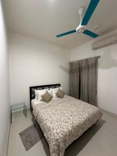a bedroom with a bed and a ceiling fan at Fairway Galle Cozy 2BR Apartment Near Beach & City in Galle